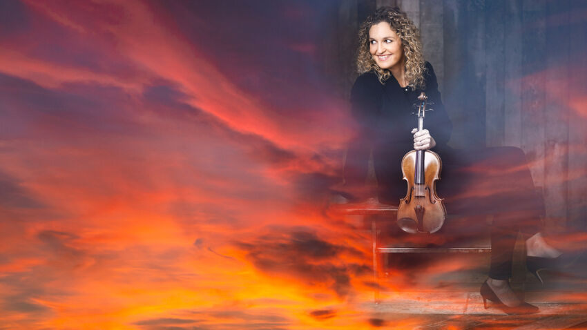 Violinist over a orange sunset