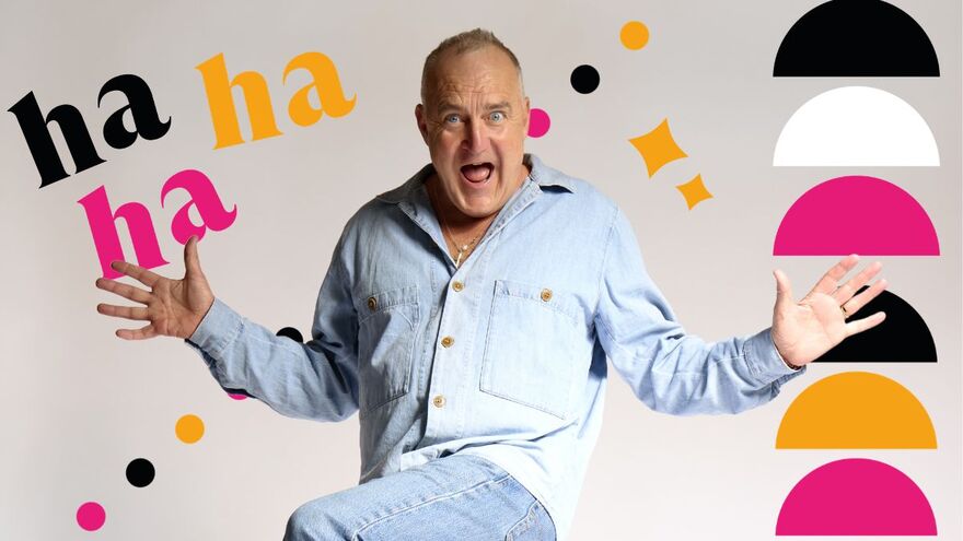 Jimeoin wearing a denim shirt with one leg raised and his hands outstreched