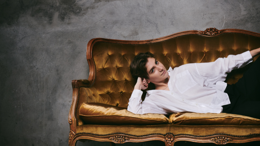 Sarah Keyworth laying on a chaise longe