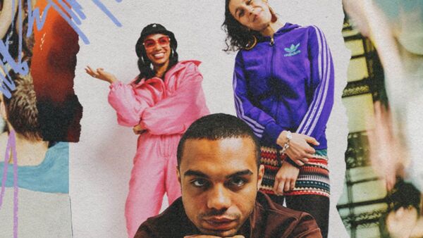 Three performers in colourful tracksuits pose for the camera