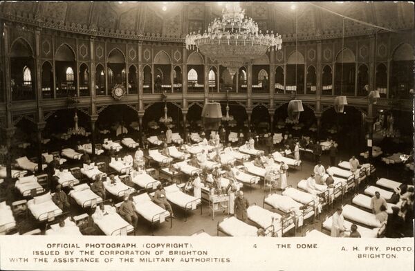 Black and white image of rows of hospital beds inside the Dome, with a chandelier above them.