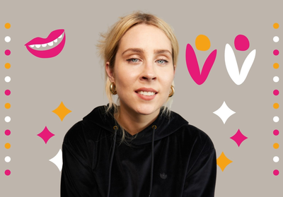 Stevie Martin wearing a black hoodie smiling at the camera