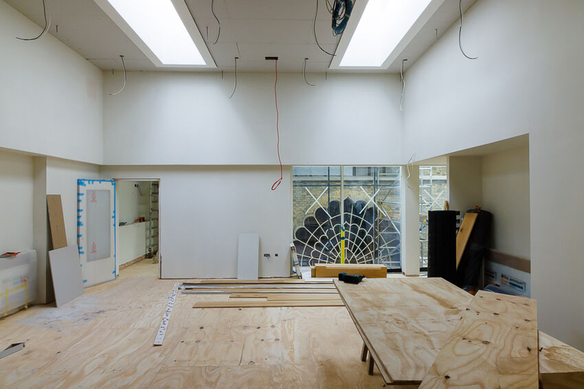 Interior of a white walled room with building work in progress
