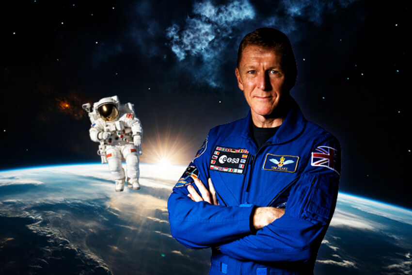 A white man in a blue space suit stands with his arms crossed, behind him is the world and an astronaut in a white space suit