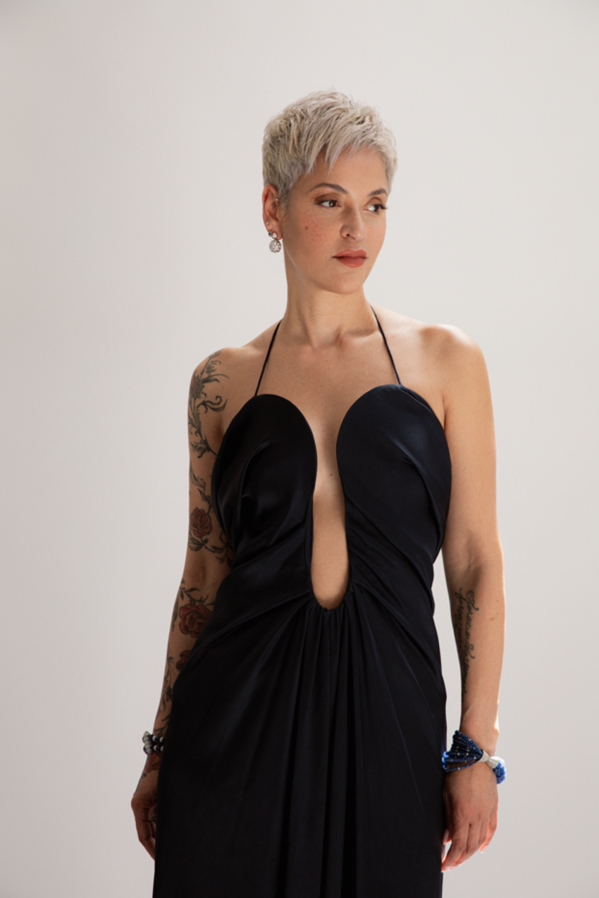 Mariza wearing a sleek black dress looking soulfully away from camera