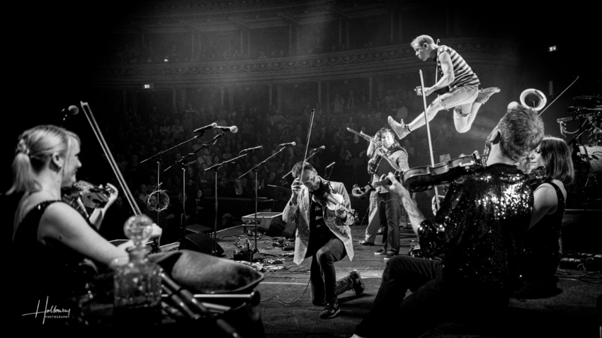 Dynamic shot of Bellowhead performing live on stage