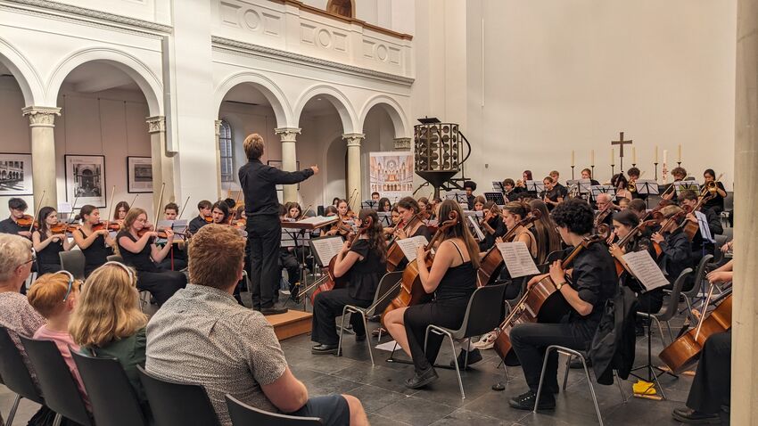 BESYO  performing in a large white room
