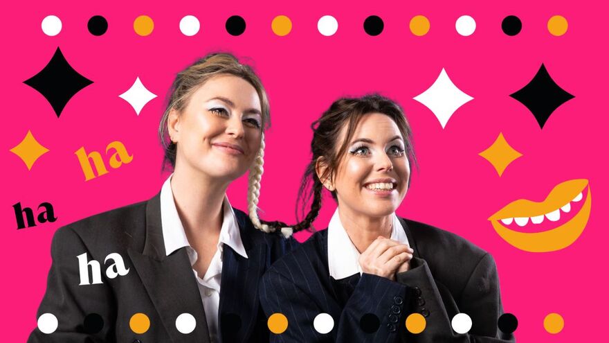Two woman wearing black suits and white skirts are smiling. One of them is holding their hands together surrounded by black, yellow and white stars and 'ha's'