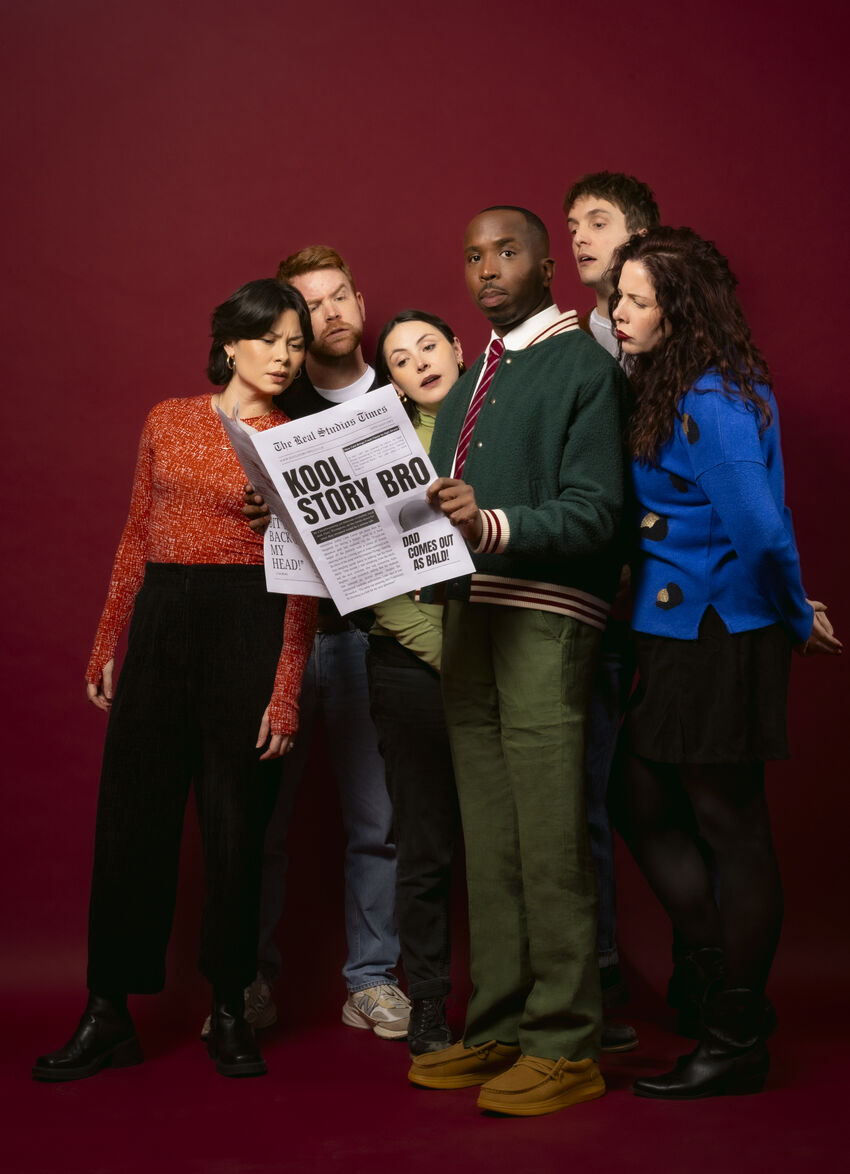 Kiell Smith-Bynoe with a group of people reading a newspaper entitled 'Kool Story Bro'