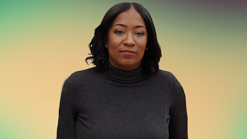 Britt Bennett wearing a black roll-neck top, with a background fading from green around the outside to yellow in the centre