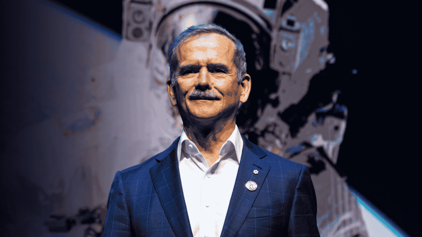 Shot of Chris Hadfield with a smile wearing a blue suit