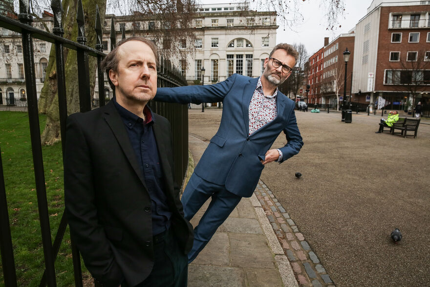 Hugh Dennis and Steve Punt stood in London next to some park railings