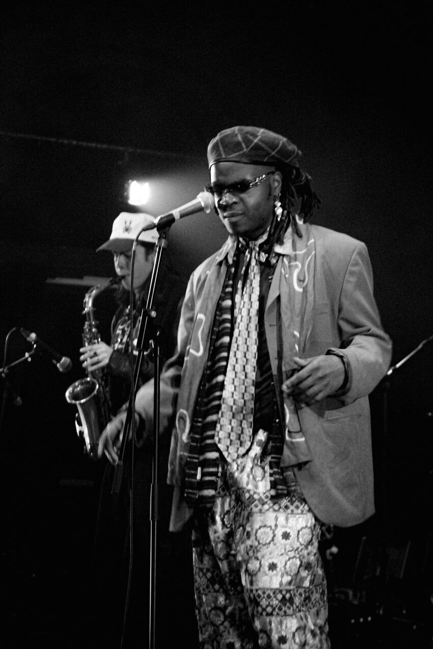 A black man standing behind a microphone