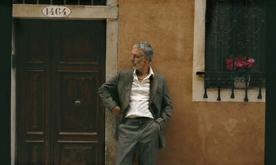 Baxter Dury standing in a street