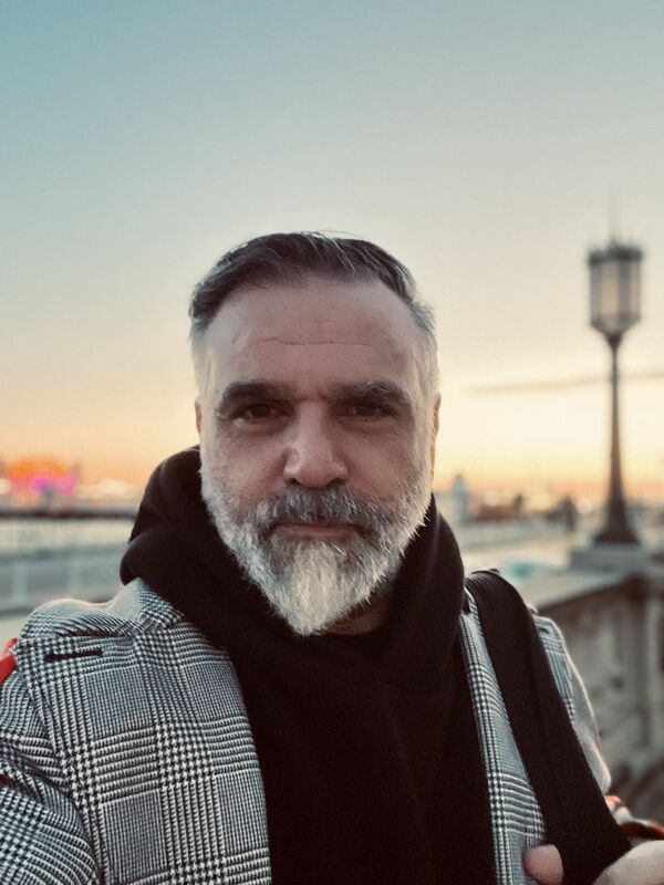 Judah Armani standing in front of Brighton Pier