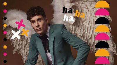 Larry Dean wearing a turquoise blazer, white shirt and black tie with angel wings made of feathers