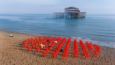 red chairs arranged in a circle looking out to pier 