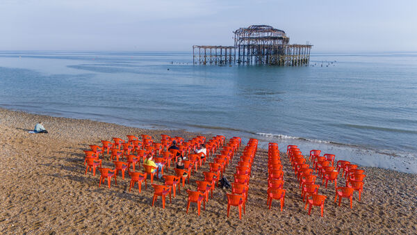 red chairs arranged in a circle looking out to pier 