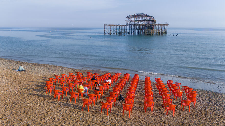 red chairs arranged in a circle looking out to pier