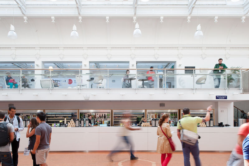 A white bar with people standing in front of it