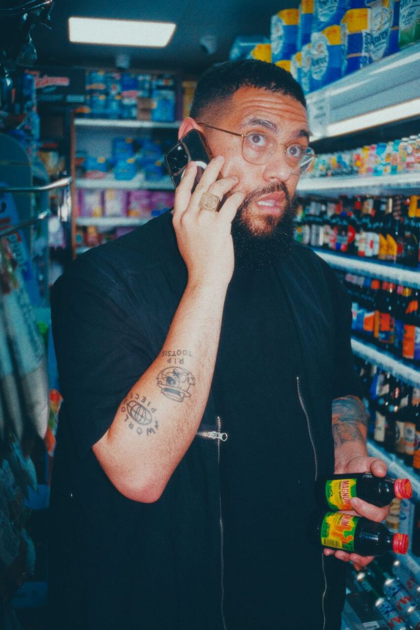 candid shot of Jamali Maddix inside store on the phone