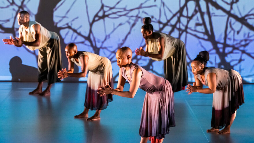 5 South African dancers on a blue stage performing Dada Masilo's The Sacrifice