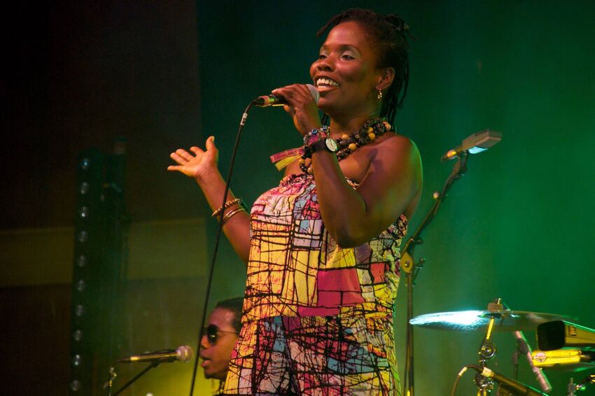 Adriana Lord in singing into a microphone on stage