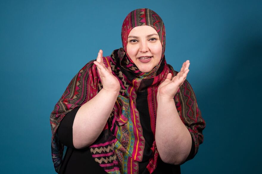 Photograph of comedian Fatiha El-Ghorri against a blue background