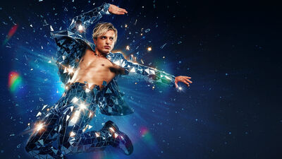 A person wearing metallic troseurs and blazer flying through the air. They are holding one arm stretched out and another over their head. There are metallic shards flying off them and they are jumping over a galaxy background