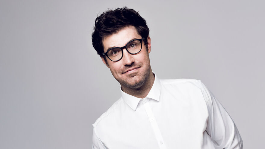 Dan Schreiber in a white shirt over a grey background