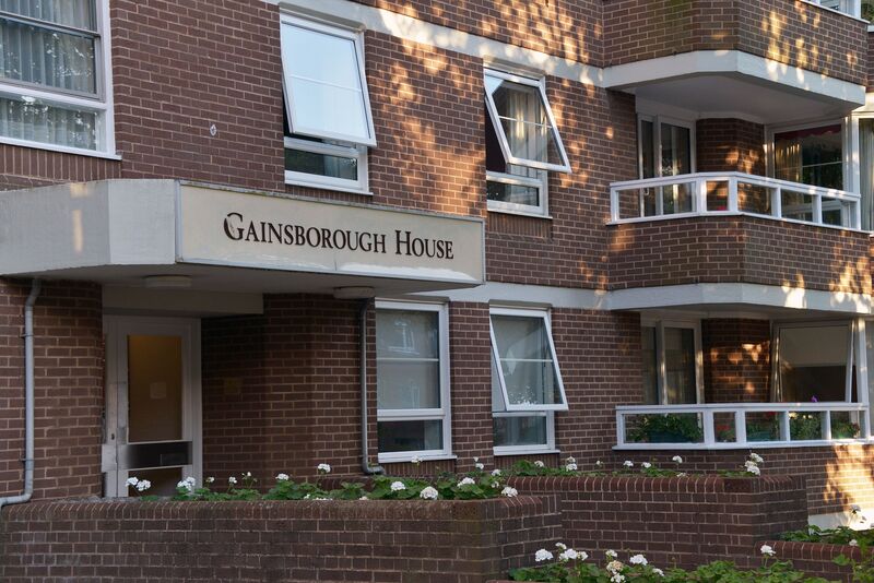 External shot of a block of flats called Gainsborough House, we can see the entrance and windows, plus balconies
