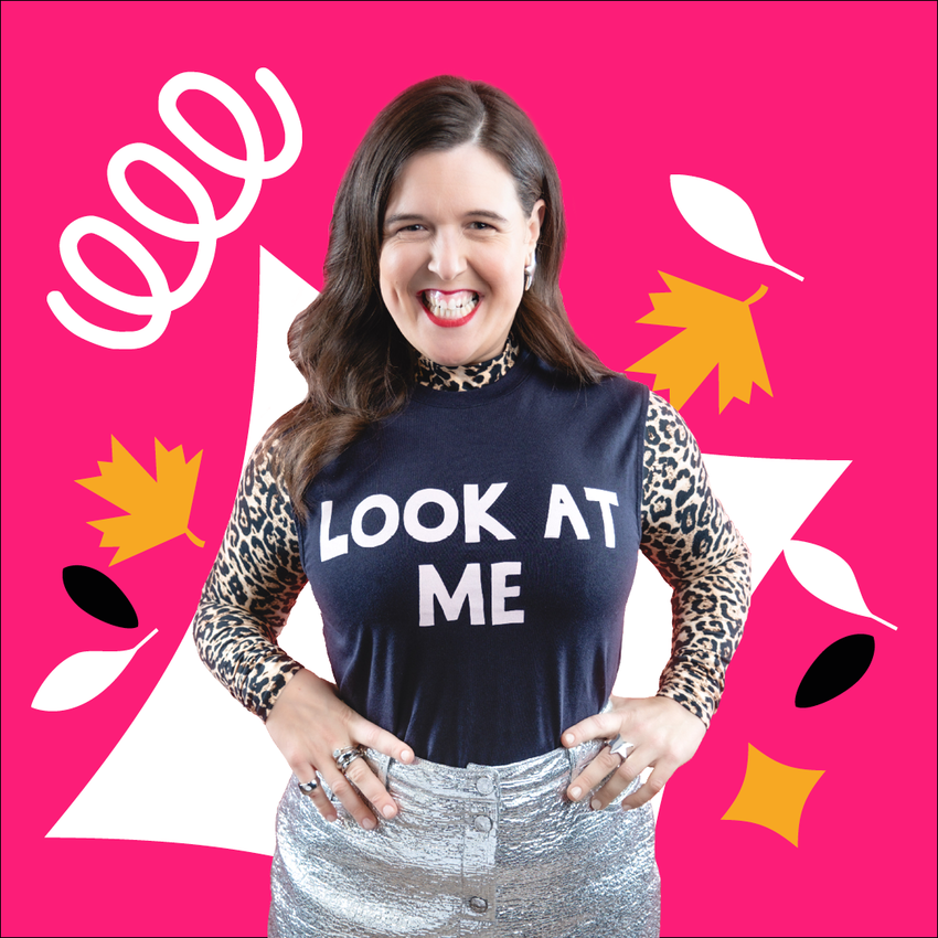 Rosie Jones standing over a pink background smiling, with a top that says 