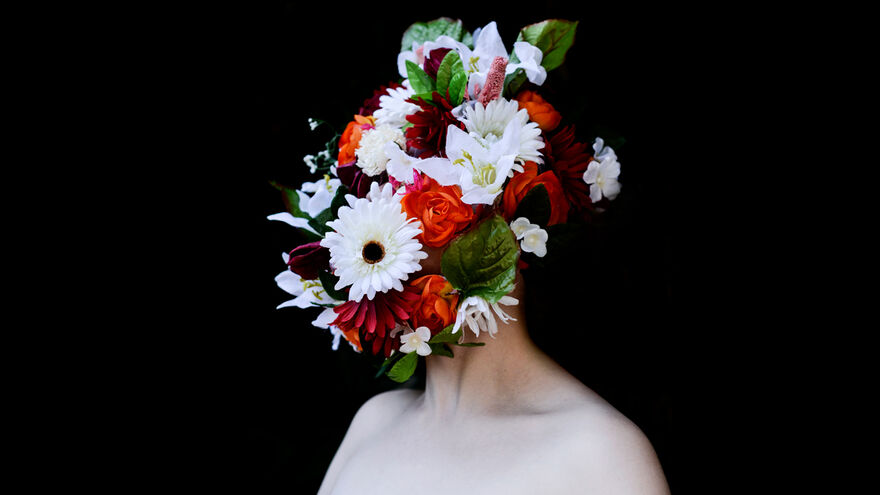 An artistic photographic portrait of flowers over a person's face