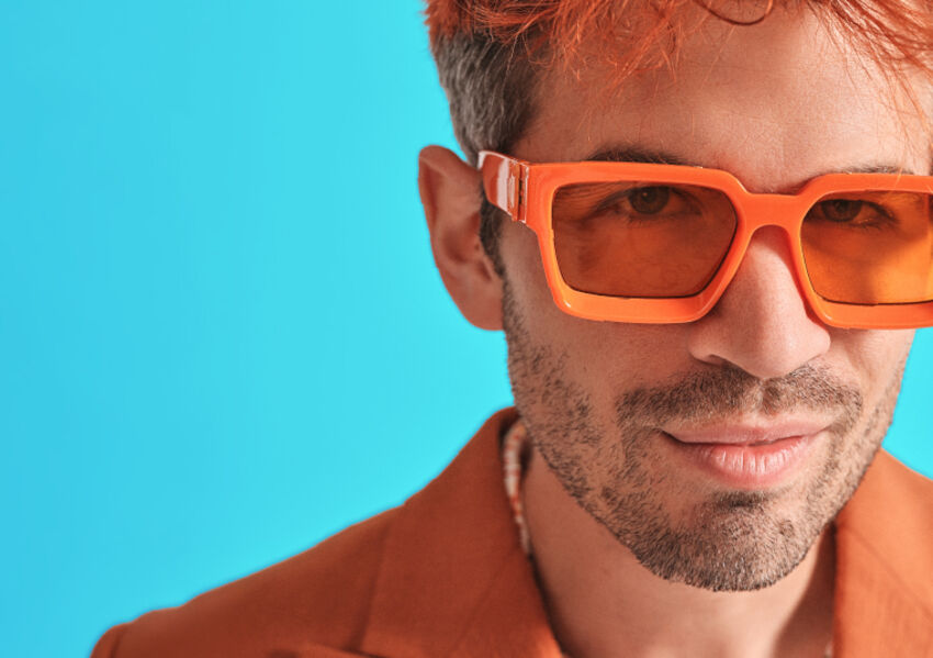 Ivo Graham wearing an orange blazer and sunglasses