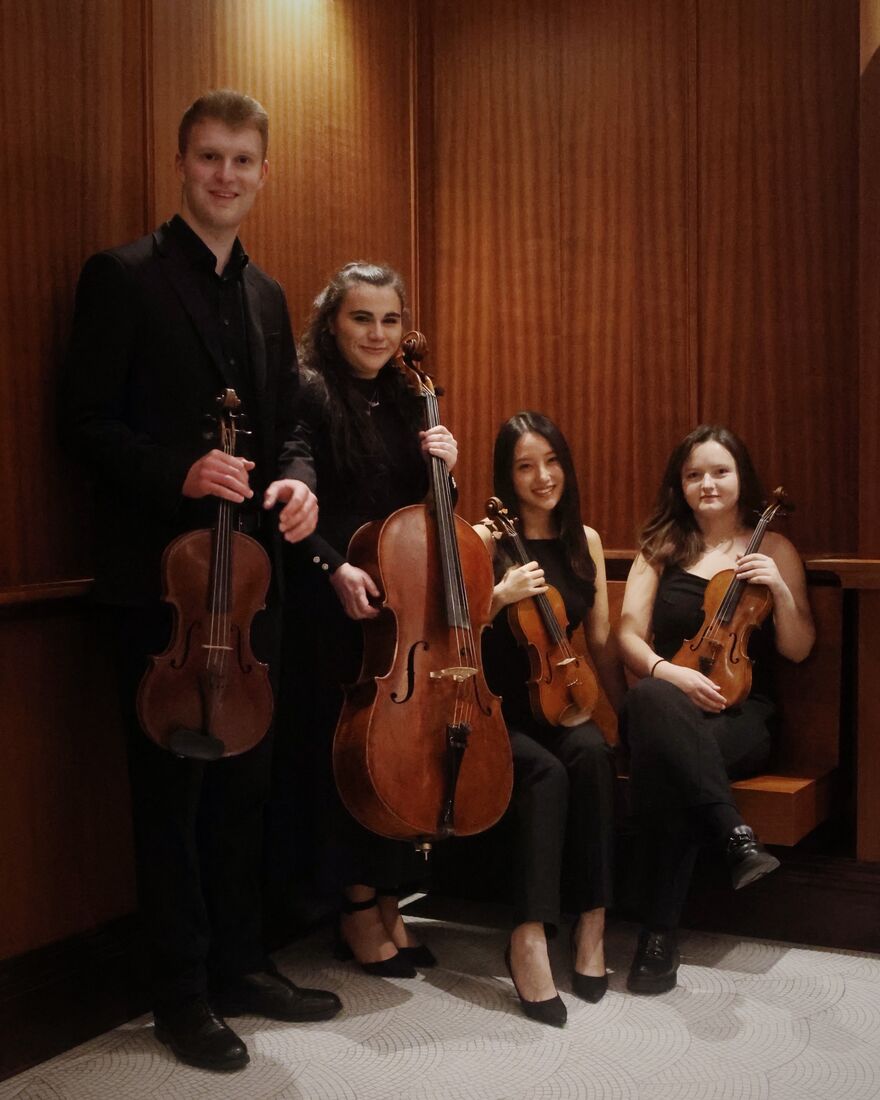 Four people in black outfits with violins, cellos and violas
