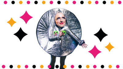 Lucy Pearman wearing a silver circle shape, holding two green alien heads, with a galaxy and star background.