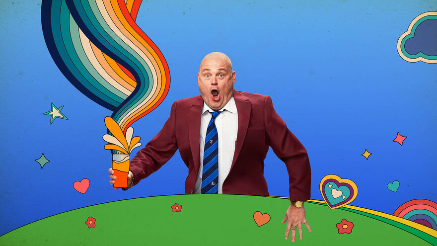 Al Murray in a red blazer and blue tie standing over a cartoon background with a pint and rainbows