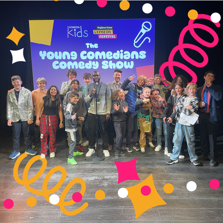 Lots of people of different ages standing in front of a sign that says 