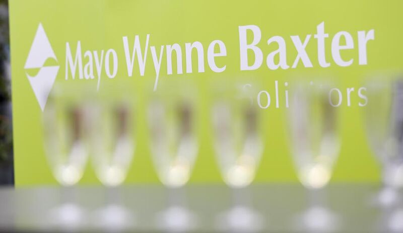 White Mayo Wynne Baxter logo printed on green background
