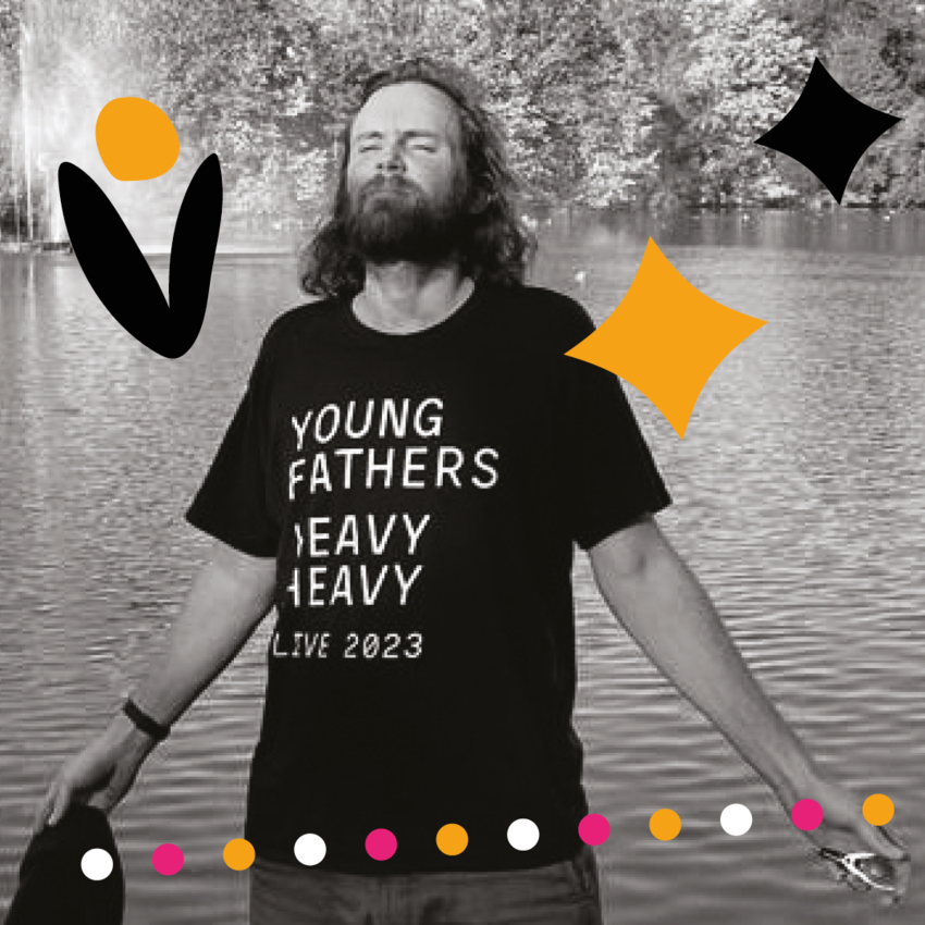 Rob Auton with his eyes closed and arms out stretched wearing a Young Fathers t-shirt