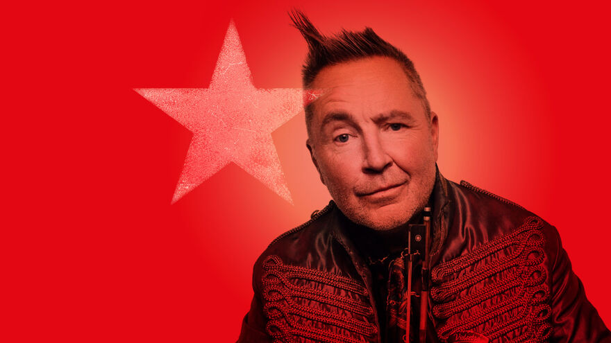 Image of Nigel Kennedy against a red background with a transparent star over the image