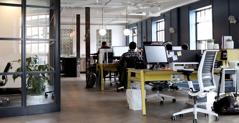 Office interior shot featuring desks and office chairs