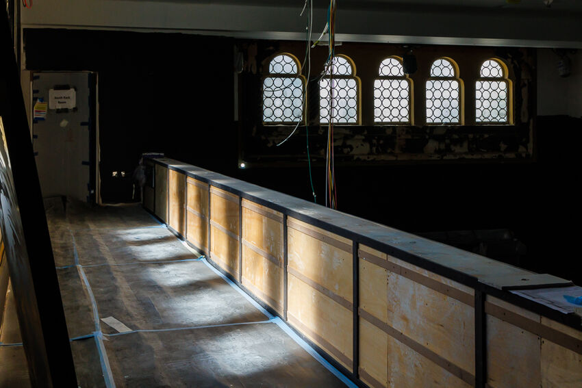 An in progress shot of the studio theatre balcony with view of 5 arched windows