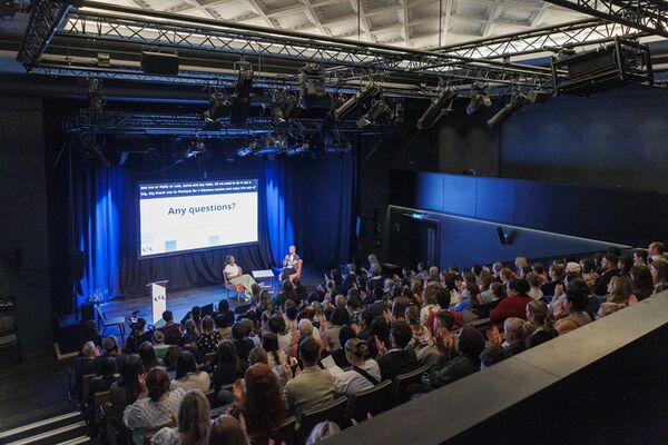 Studio Theatre viewed from the balcony, with people watching a talk from the stalls