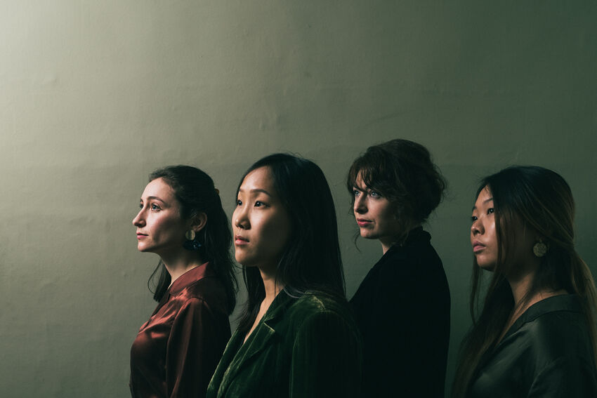 four women pose showing their side profiles