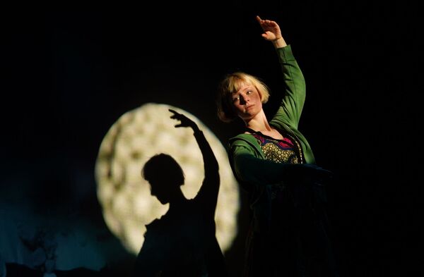 Actress standing in a ballet position over a moon