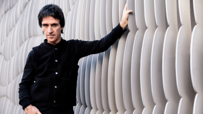 Johnny Marr leaning against a wall
