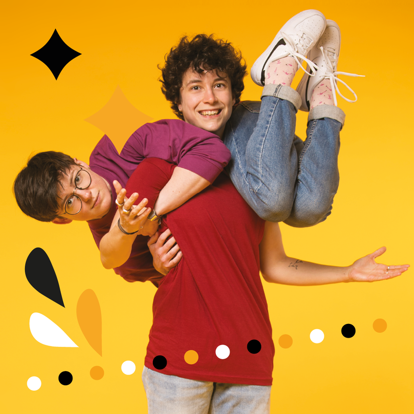 Rachel WD and Ruby Clyde both have short brown hair and are wearing casual clothes. On is lying across the shoulders of the other