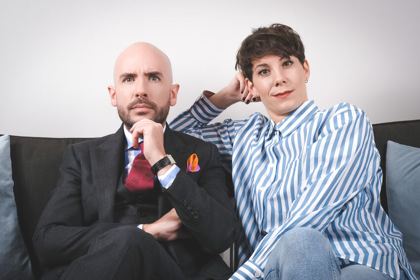Suzi Ruffell and Tom Allen sitting on a sofa