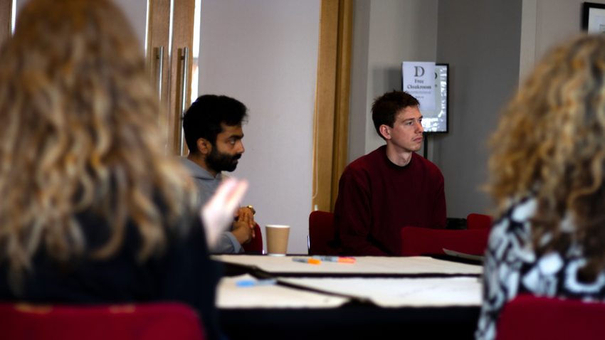 four people at a table in Brighton Dome Founders Room with paper and pens